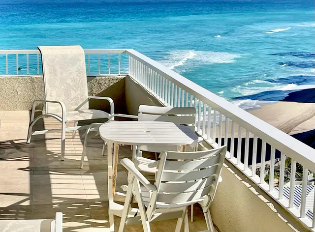 a dining room with furniture large windows and wooden floor