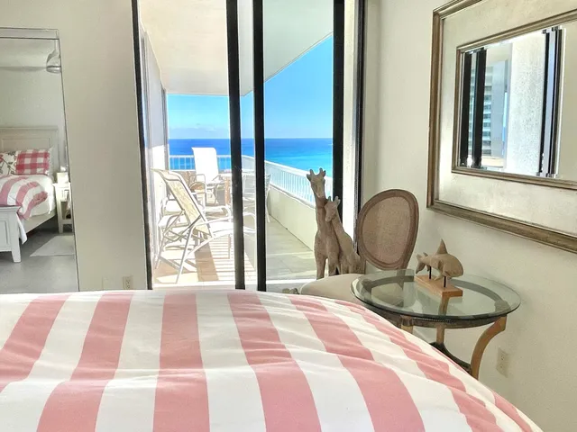 a living room with furniture and large windows