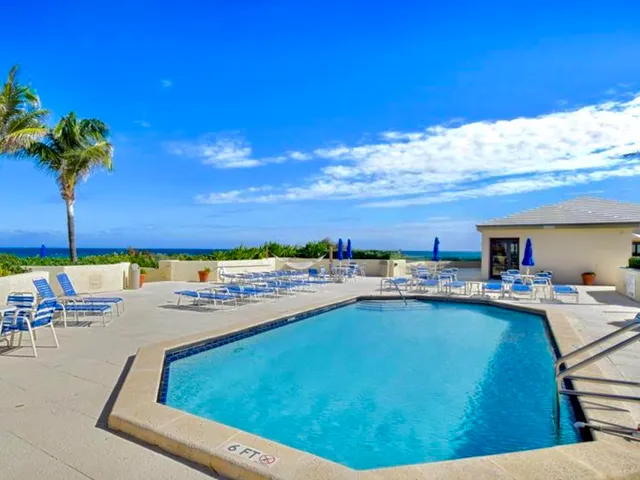 a living room with couches a coffee table and a flat screen tv