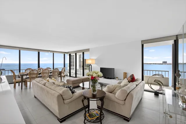 a living room with furniture and a floor to ceiling window