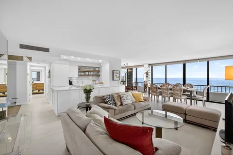a dining room with furniture a chandelier and wooden floor