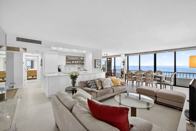 a dining room with furniture a chandelier and wooden floor