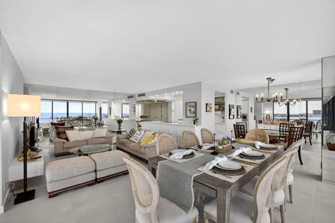 a living room with furniture and large windows