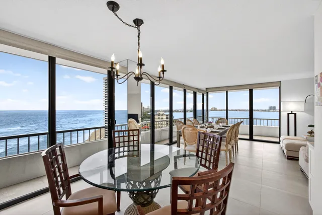 a living room with furniture and large windows
