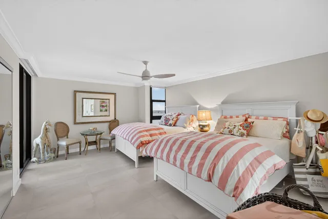 a view of a kitchen with kitchen island stainless steel appliances refrigerator stove dining table and chairs