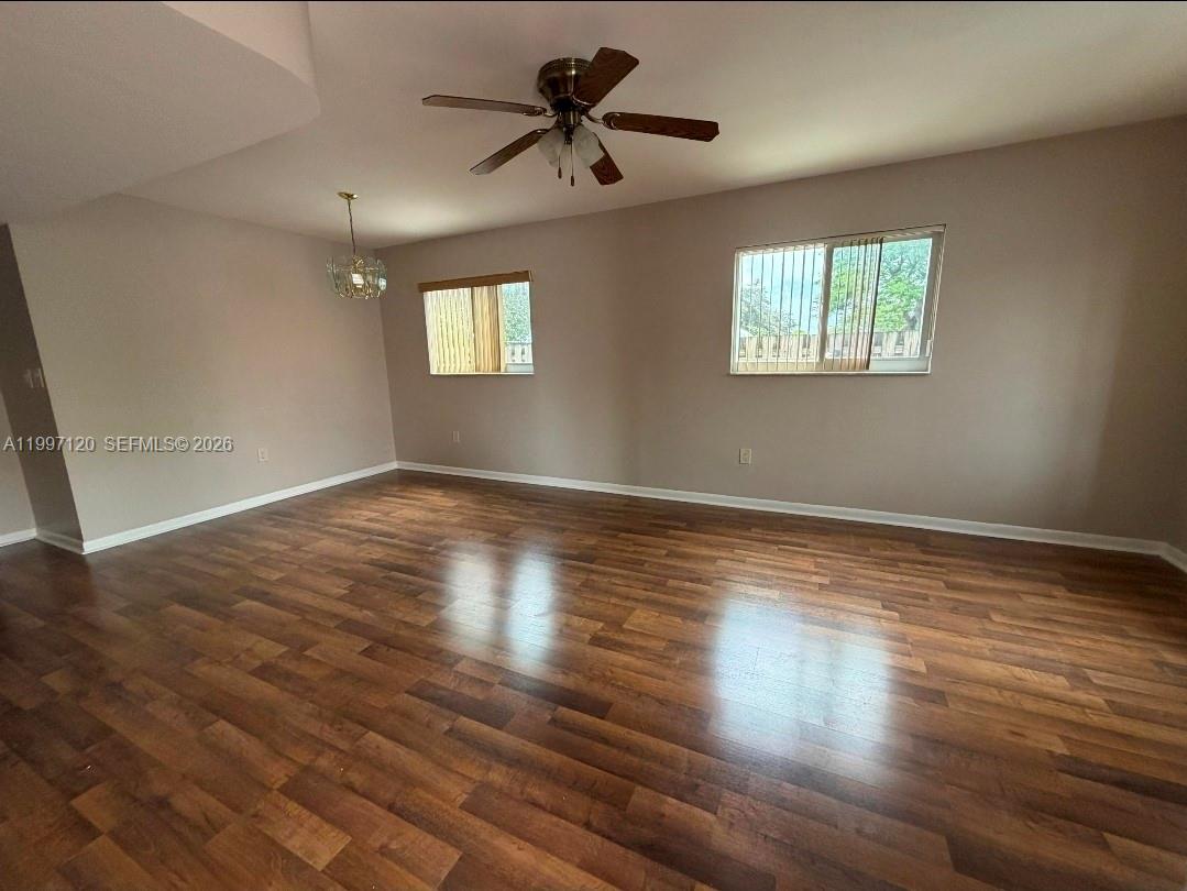 2385 West 69th Street, Unit 2385B Hialeah, FL 33016 - Photo 2 of 7 a view of room with hardwood floor and a ceiling fan