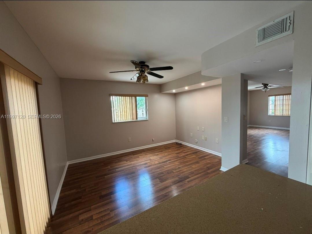 2385 West 69th Street, Unit 2385B Hialeah, FL 33016 - Photo 5 of 7 a view of empty room with wooden floor and fan