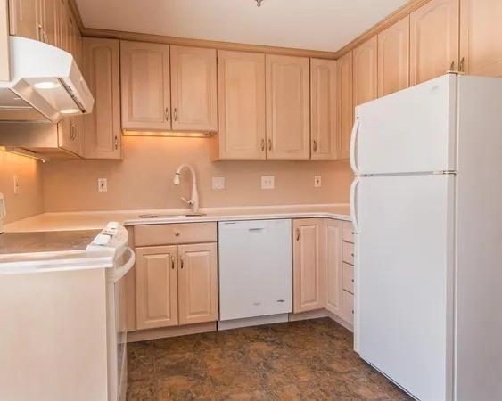 a white refrigerator freezer sitting inside of a kitchen