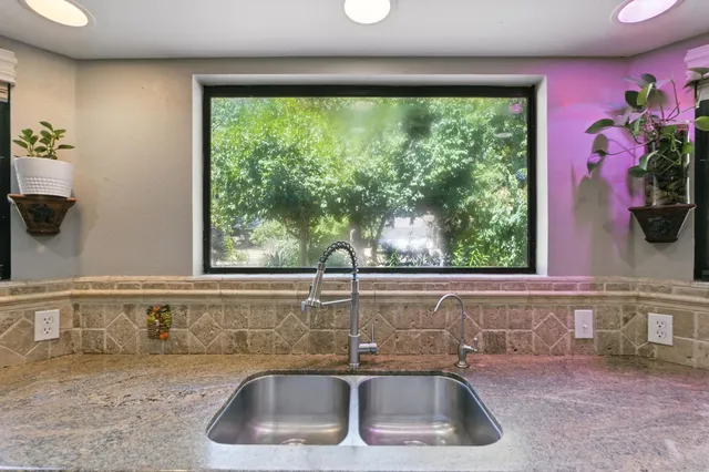 a bedroom with bed and glass windows