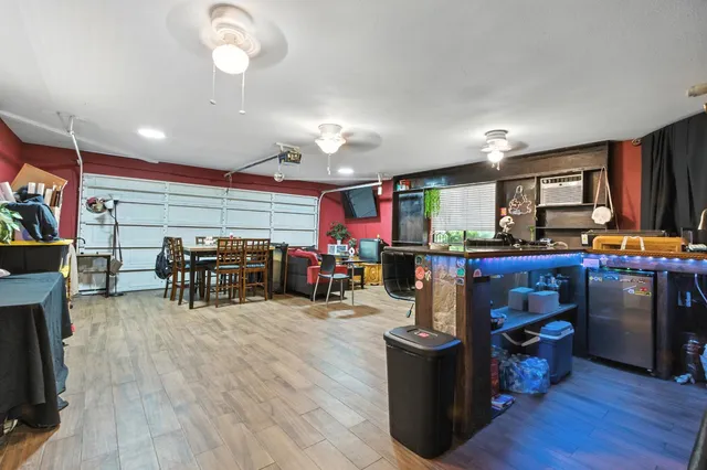 a bathroom with a granite countertop sink a mirror a toilet and shower