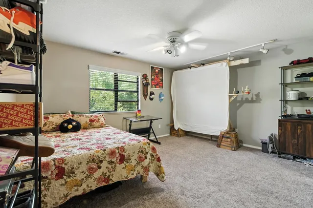 a view of backyard with outdoor seating and trees