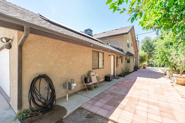 a view of a swimming pool with lounge chairs in patio