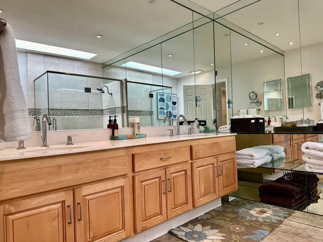 a spacious bathroom with a double vanity sink mirror and