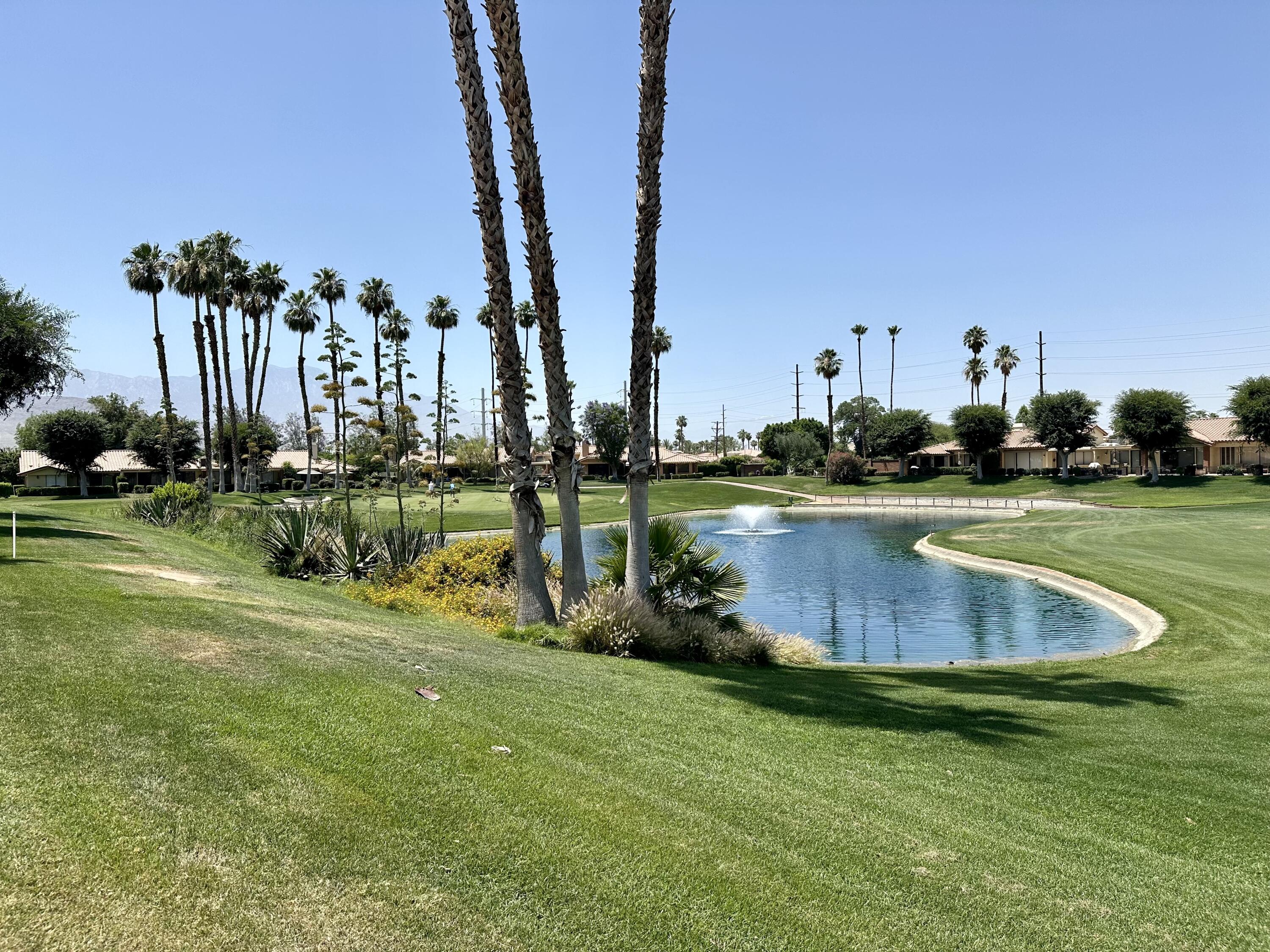 214 La Paz Way Palm Desert, CA 92260 - Photo 2 of 15 a view of a garden with a building in the background