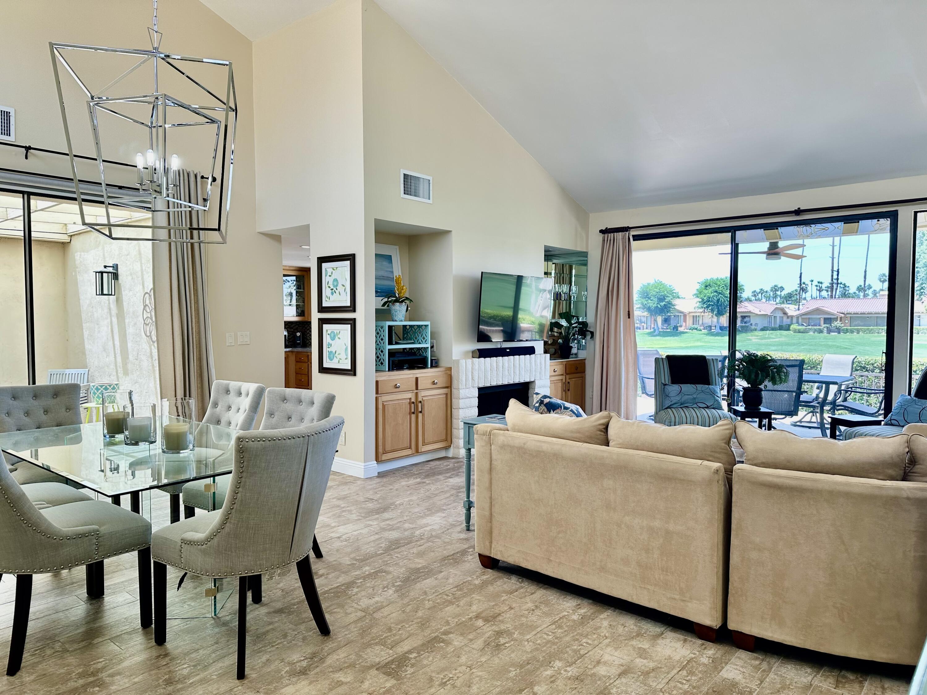 214 La Paz Way Palm Desert, CA 92260 - Photo 4 of 15 a living room with furniture and a large window