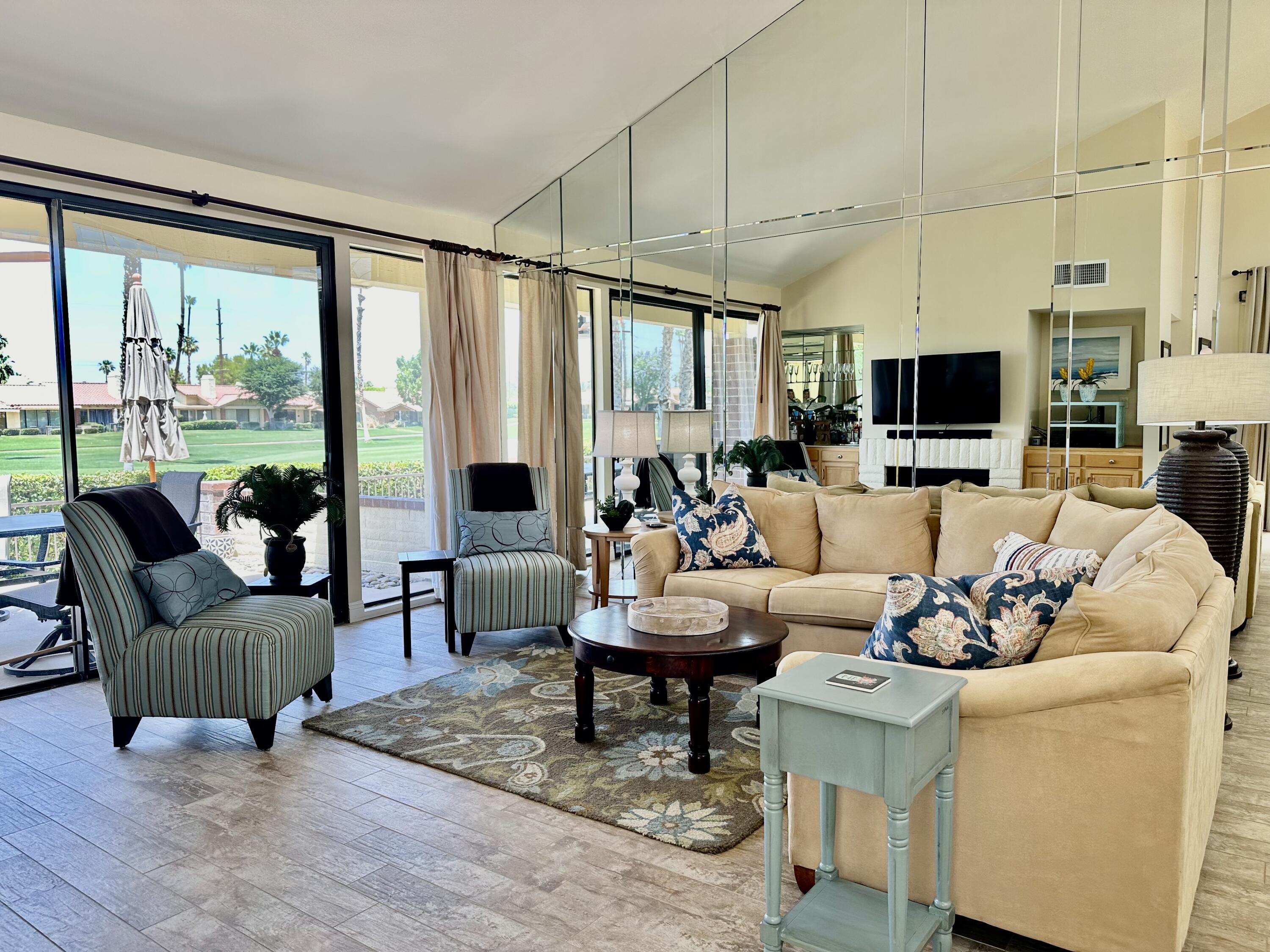214 La Paz Way Palm Desert, CA 92260 - Photo 5 of 15 a living room with furniture and a flat screen tv