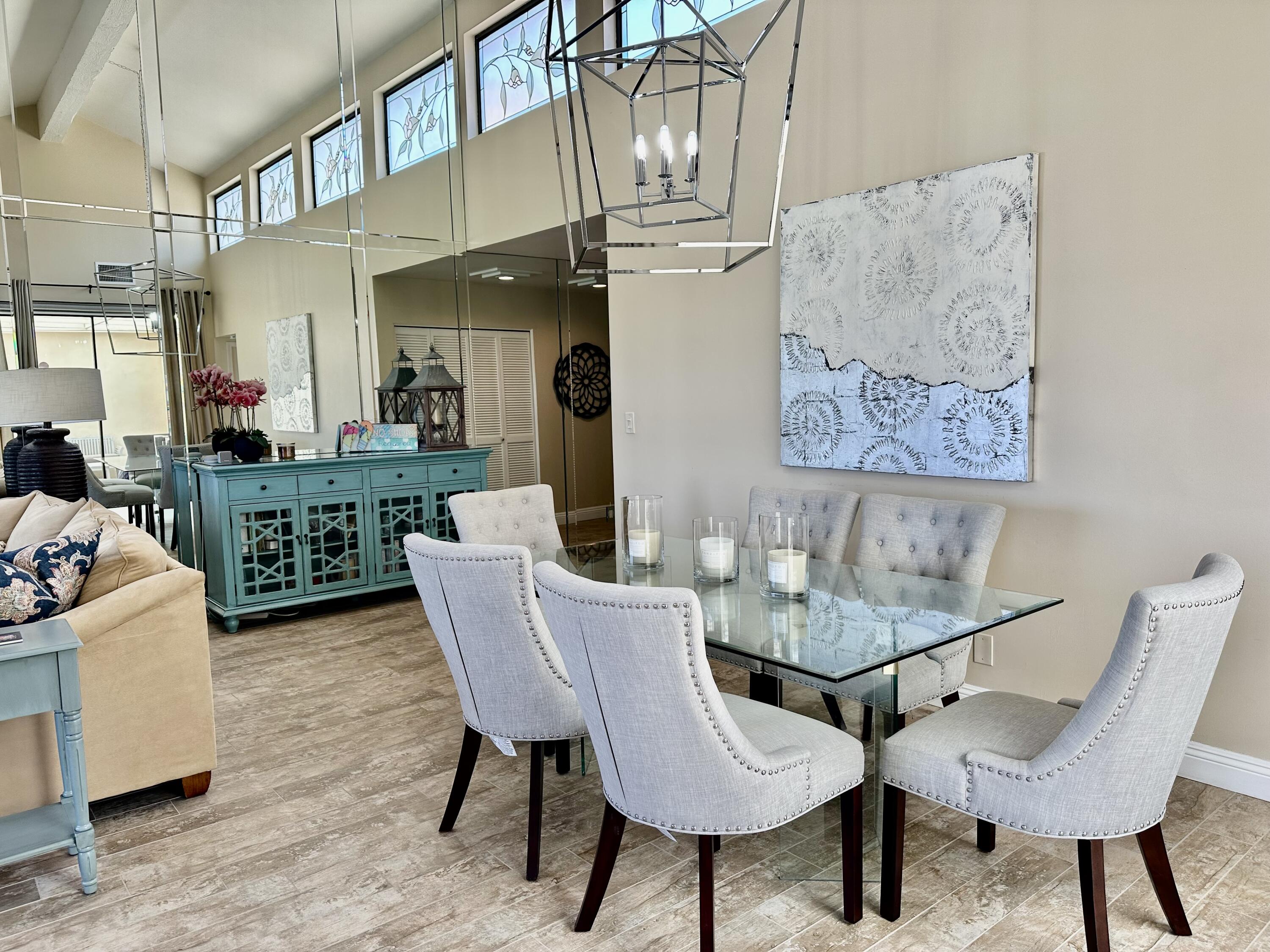 214 La Paz Way Palm Desert, CA 92260 - Photo 6 of 15 a view of a dining room with furniture a chandelier and wooden floor