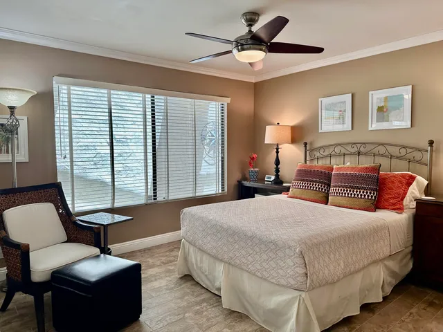 a bedroom with bed couch and window