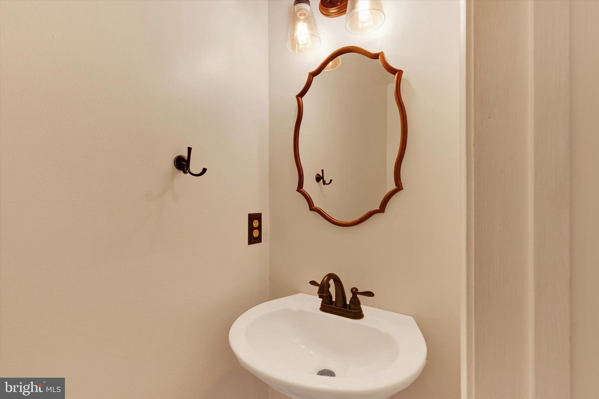 477 Longmeadow Road Lancaster, PA 17601 - Photo 8 of 28 a bathroom with a sink and mirror