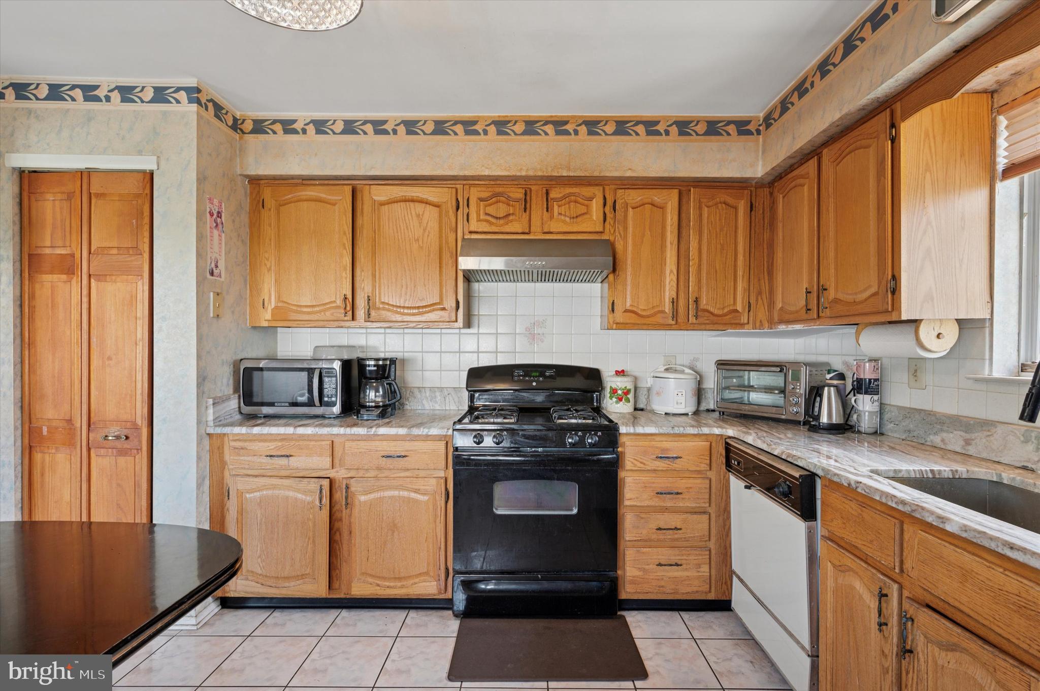 12818 Galdi Lane Philadelphia, PA 19154 - Photo 11 of 25 a kitchen with a stove top oven sink and cabinets