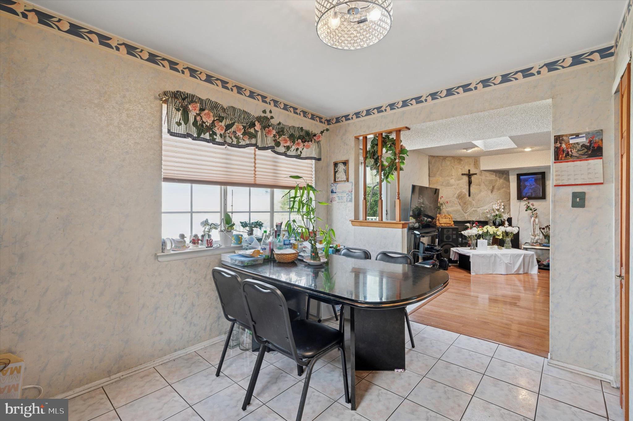 12818 Galdi Lane Philadelphia, PA 19154 - Photo 12 of 25 a dining hall with stainless steel appliances a table and chairs with wooden floor
