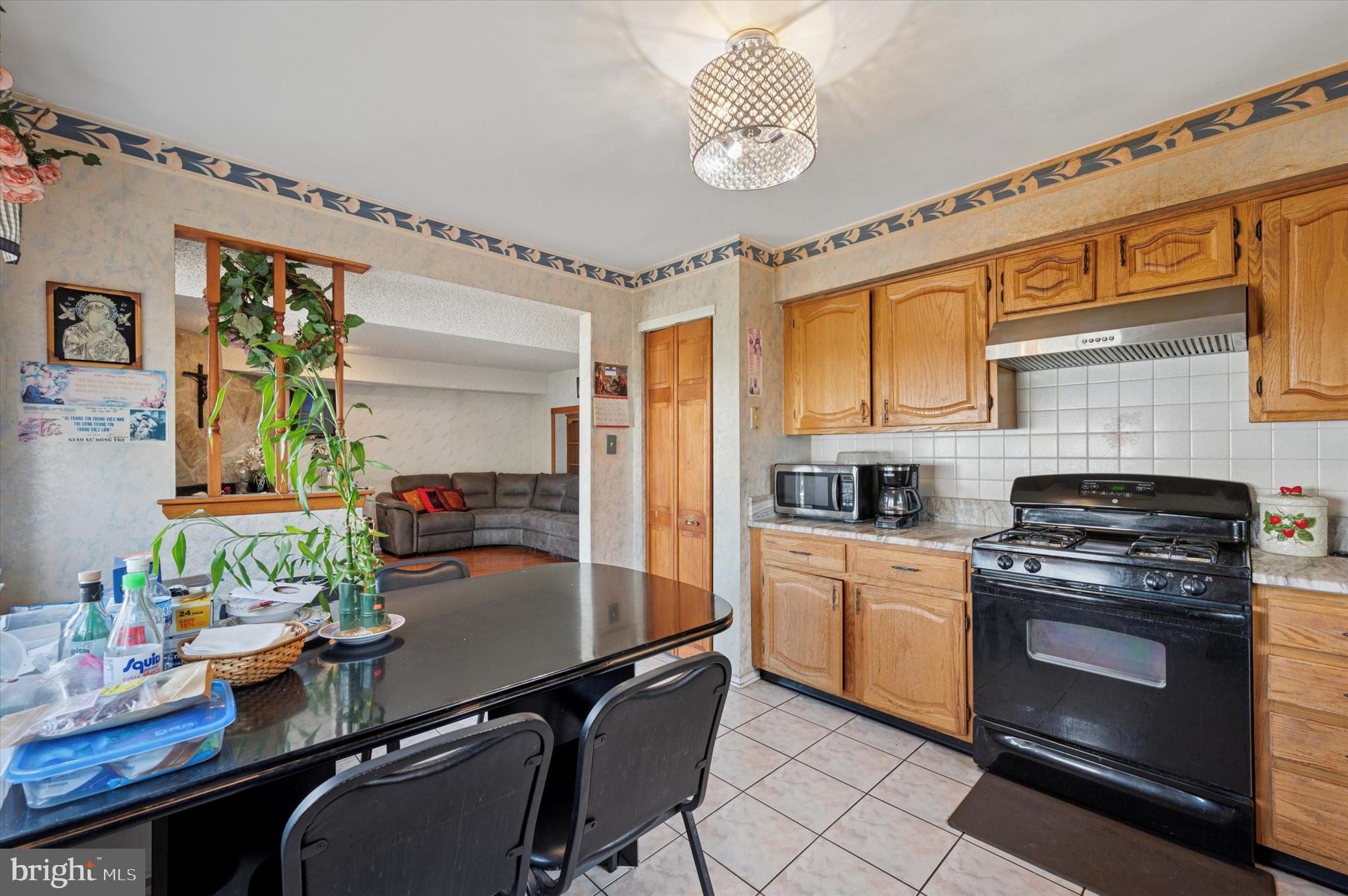 12818 Galdi Lane Philadelphia, PA 19154 - Photo 13 of 25 a kitchen with a table chairs stove and cabinets