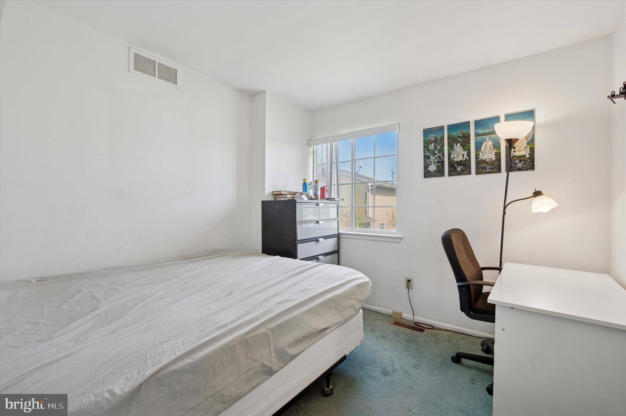 12818 Galdi Lane Philadelphia, PA 19154 - Photo 17 of 25 a bedroom with a bed a desk and chair