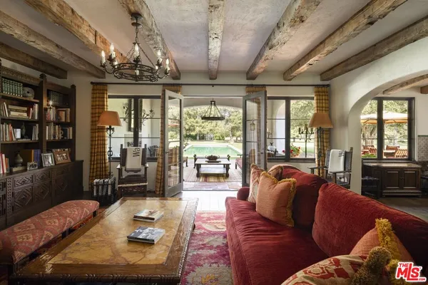 a living room with furniture and a chandelier