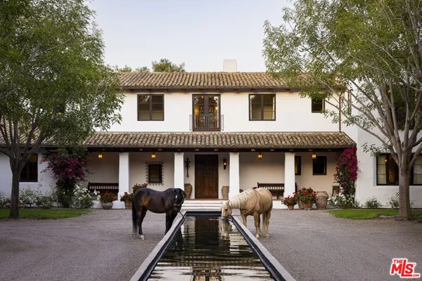 a front view of a house with glass windows