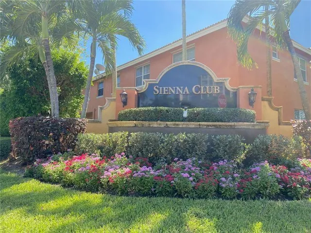 a view of a flower in front of a house