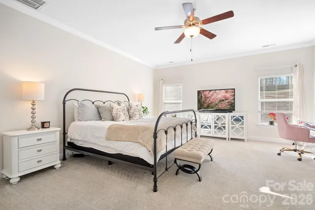 a spacious bedroom with a bed and a couch