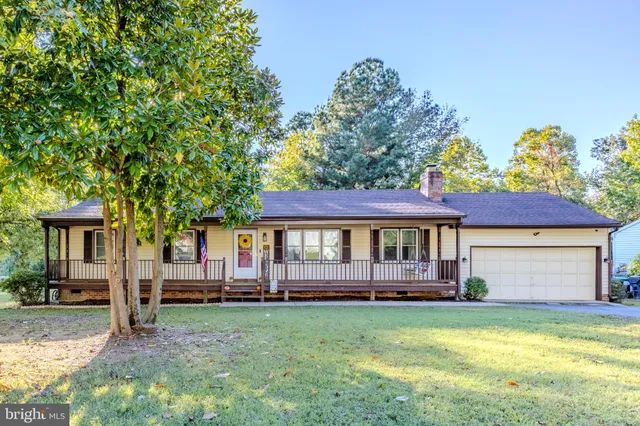 a front view of a house with a garden and deck