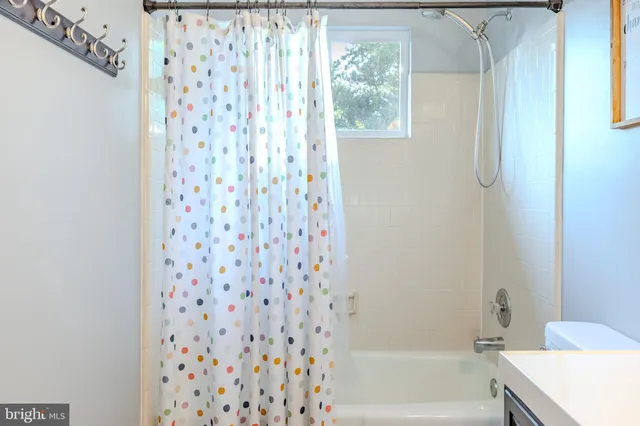 a bathroom with a shower curtain and a bath tub