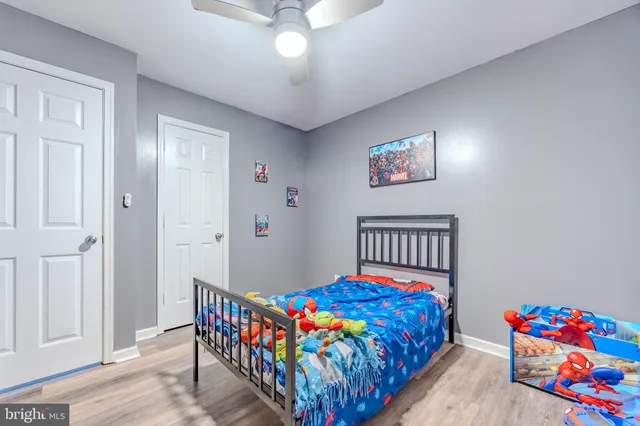 a bedroom with bed and a baby crib