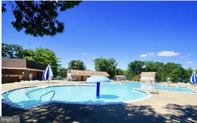 a view of a swimming pool with a yard