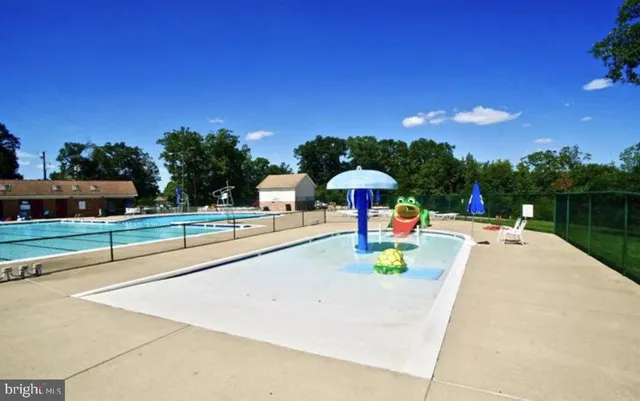 a view of swimming pool with a lounge chairs