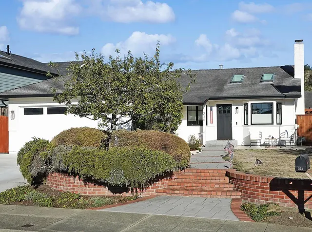 a front view of a house with garden