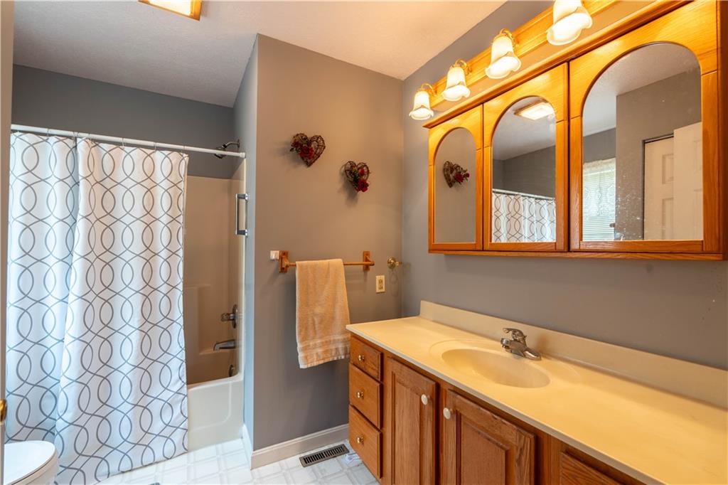 4487 Battle Ridge Road Oakdale, PA 15071 - Photo 24 of 46 a bathroom with a granite countertop sink and a mirror