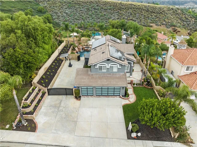 an aerial view of a house with a yard