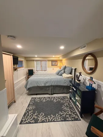 a living room with furniture a rug and a flat screen tv