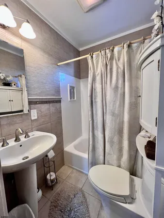 a bathroom with a granite countertop sink a mirror and a shower