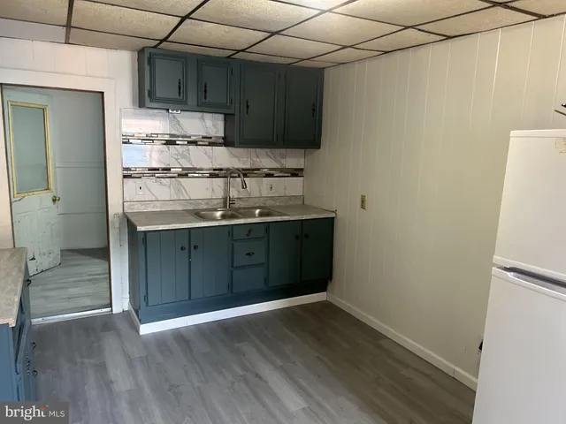 a kitchen with stainless steel appliances granite countertop a sink and wooden floor