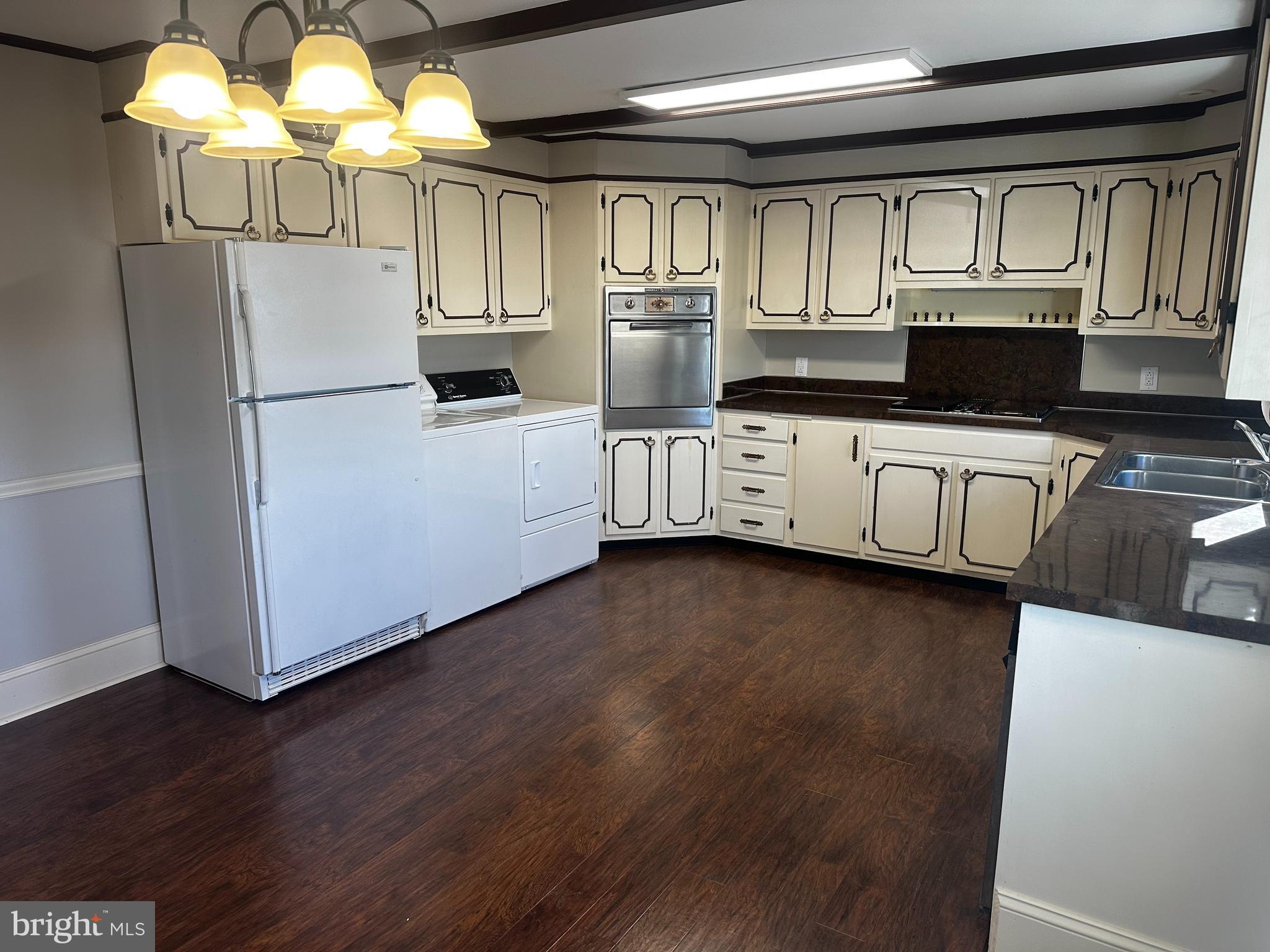 659 North Main Street Doylestown, PA 18901 - Photo 11 of 22 a kitchen with stainless steel appliances granite countertop a refrigerator oven a sink dishwasher and white cabinets with wooden floor