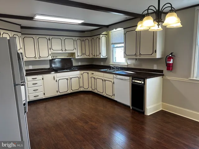 a kitchen with granite countertop a sink and cabinets