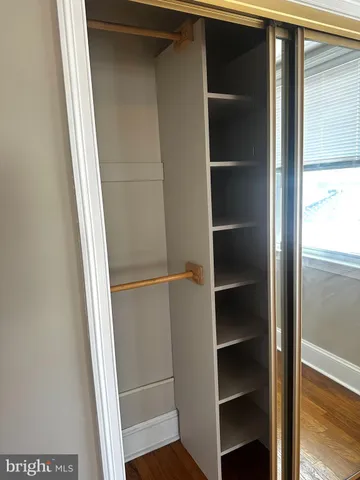 a view of walk in closet with empty racks