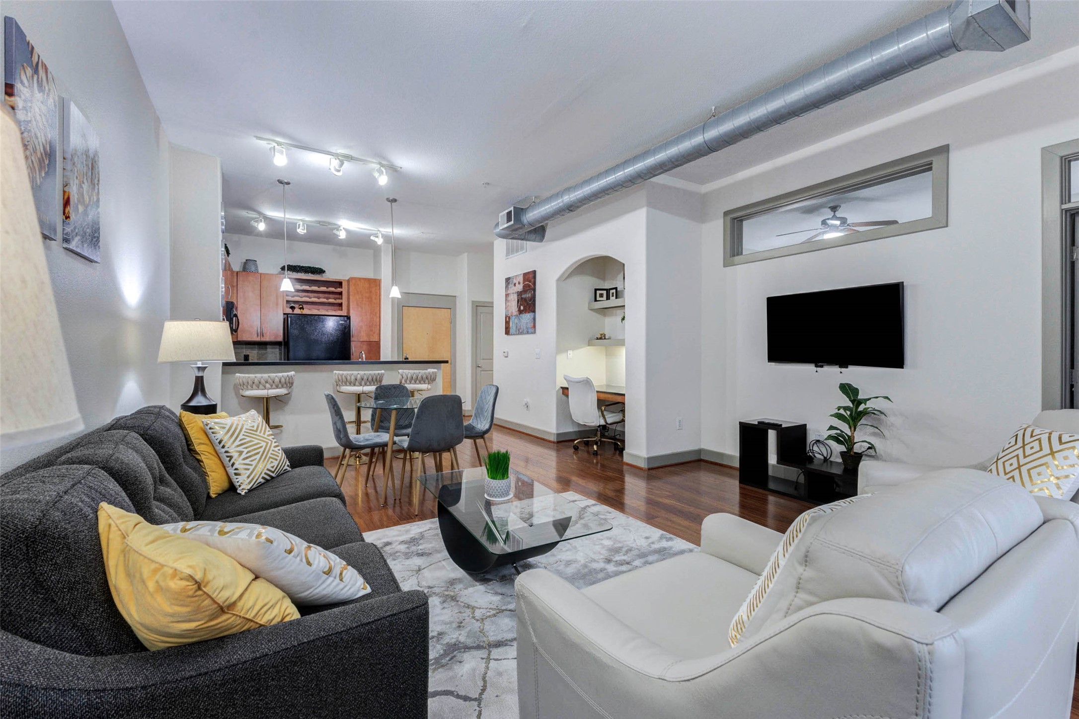 1901 Post Oak Boulevard, Unit 1106 Houston, TX 77056 - Photo 13 of 26 a living room with furniture and a flat screen tv