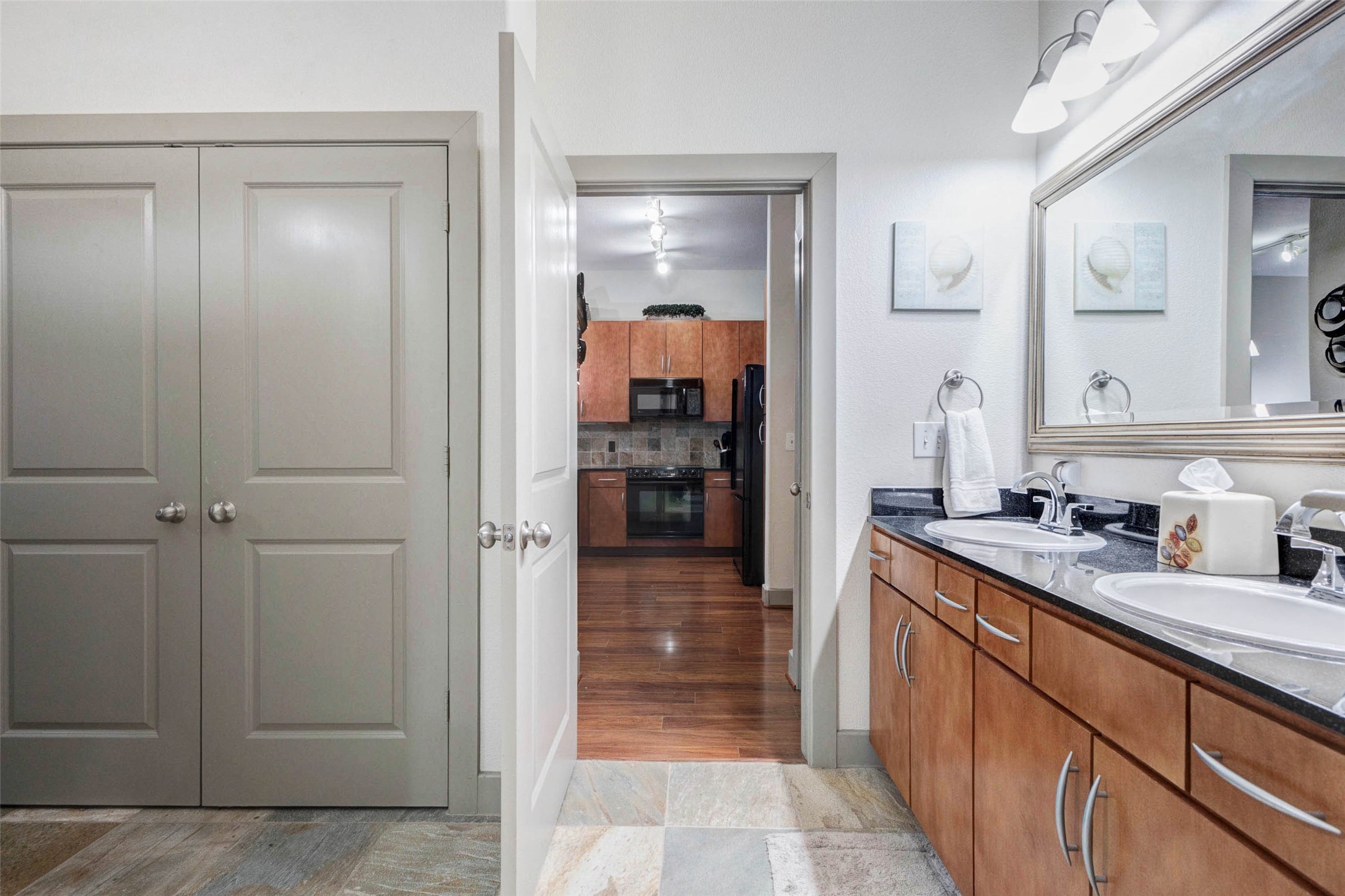 1901 Post Oak Boulevard, Unit 1106 Houston, TX 77056 - Photo 20 of 26 a bathroom with a sink and mirror