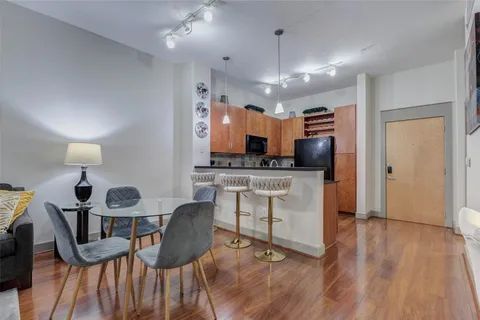 a kitchen with stainless steel appliances wooden floors stove a sink and a microwave