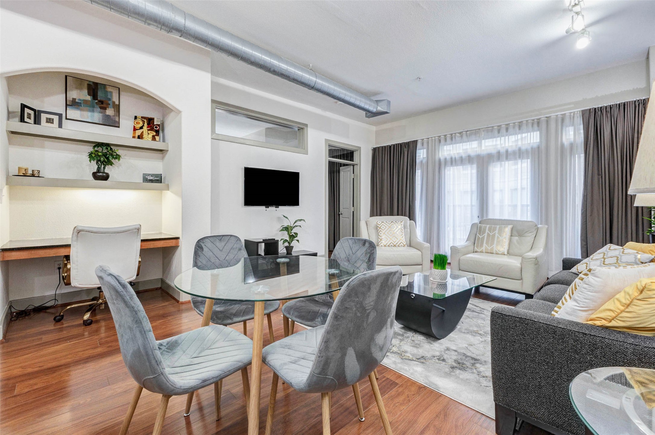1901 Post Oak Boulevard, Unit 1106 Houston, TX 77056 - Photo 5 of 26 a living room with furniture a rug and a flat screen tv