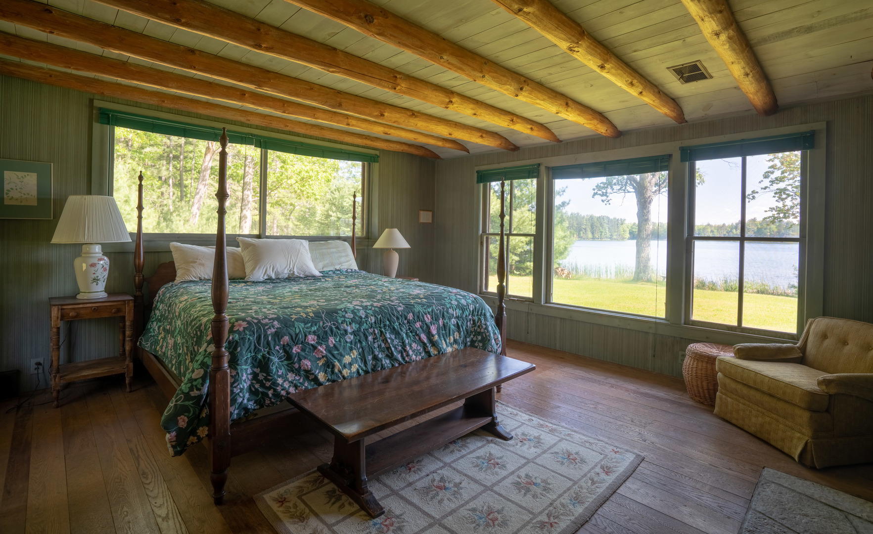 5021 Solomon Road Atlanta, MI 49709 - Photo 25 of 34 a bedroom with a bed wooden floor and a large window